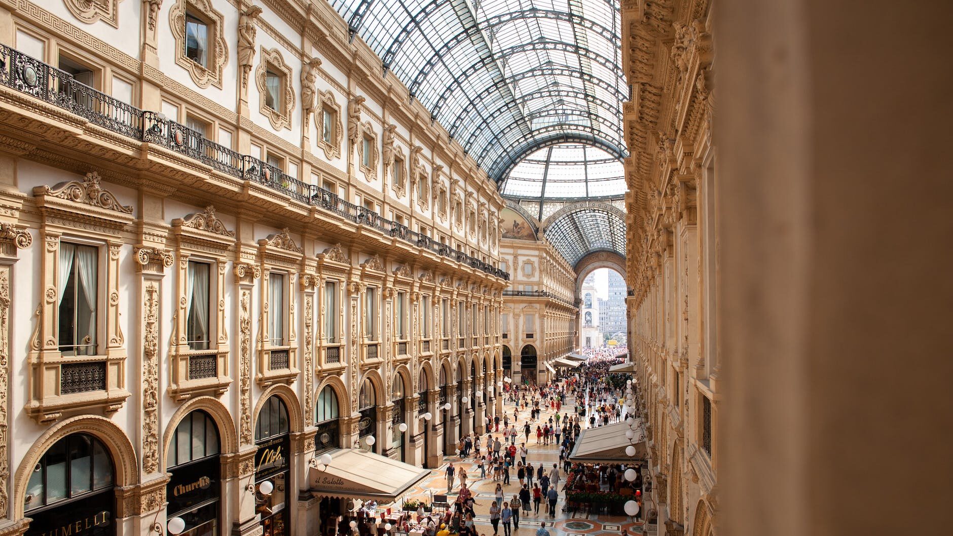 people inside galleria vittorio emanuele ii shopping mall in italy